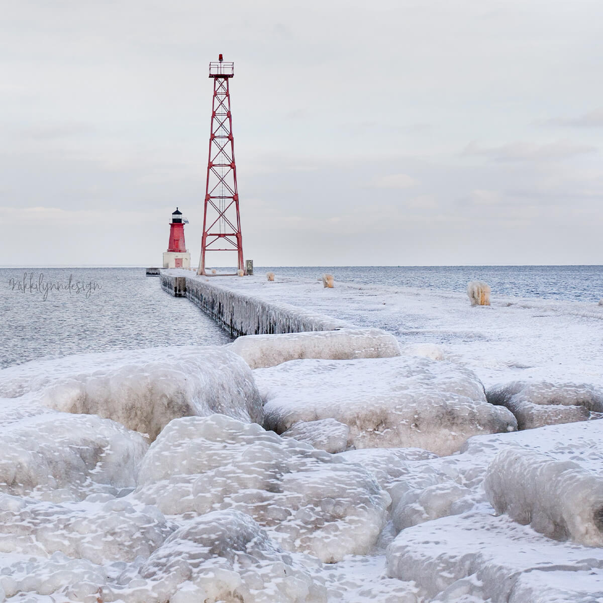 Menominee North Pier Lighthouse surrounded by winter ice on Lake Michigan