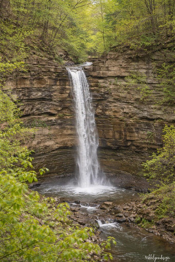 Big Clifty Falls waterfall cascading over limestone cliffs at Clifty Falls State Park in Madison Indiana.