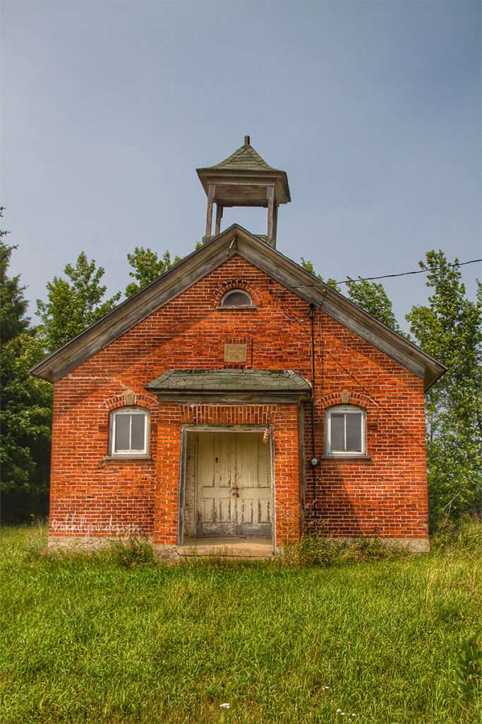 Historic brick one-room schoolhouse with bell tower in southern Door County Wisconsin.