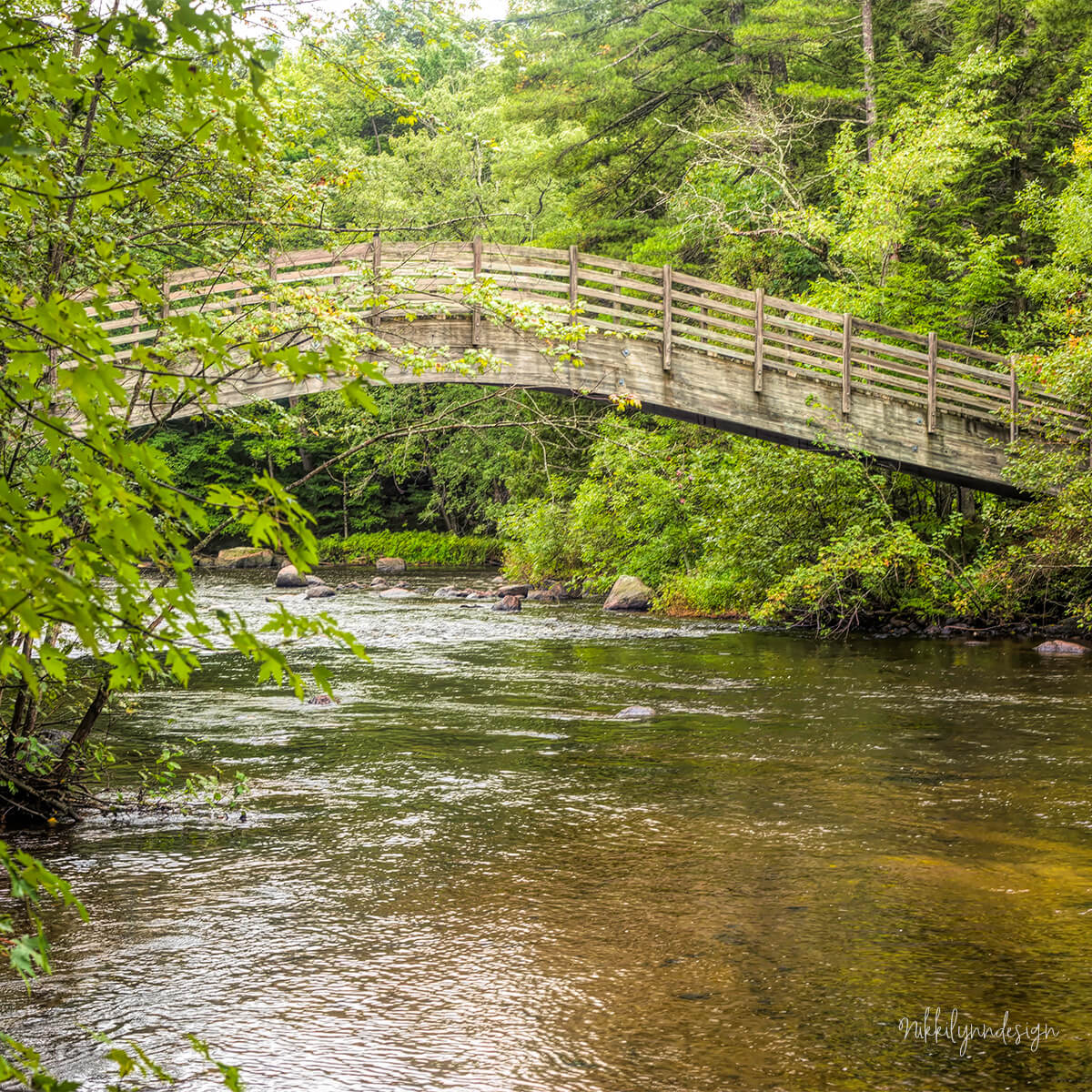 Wooden footbridge over the Peshtigo River at McClintock Park in Marinette County Wisconsin