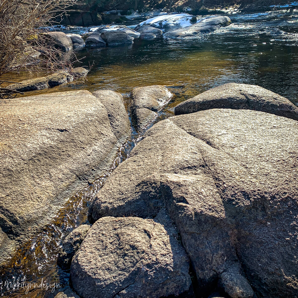 Glimmer Falls in Richmond, Wisconsin with smooth rock ledges, flowing water, surrounding forest, and nearby wildlife and woodland details.