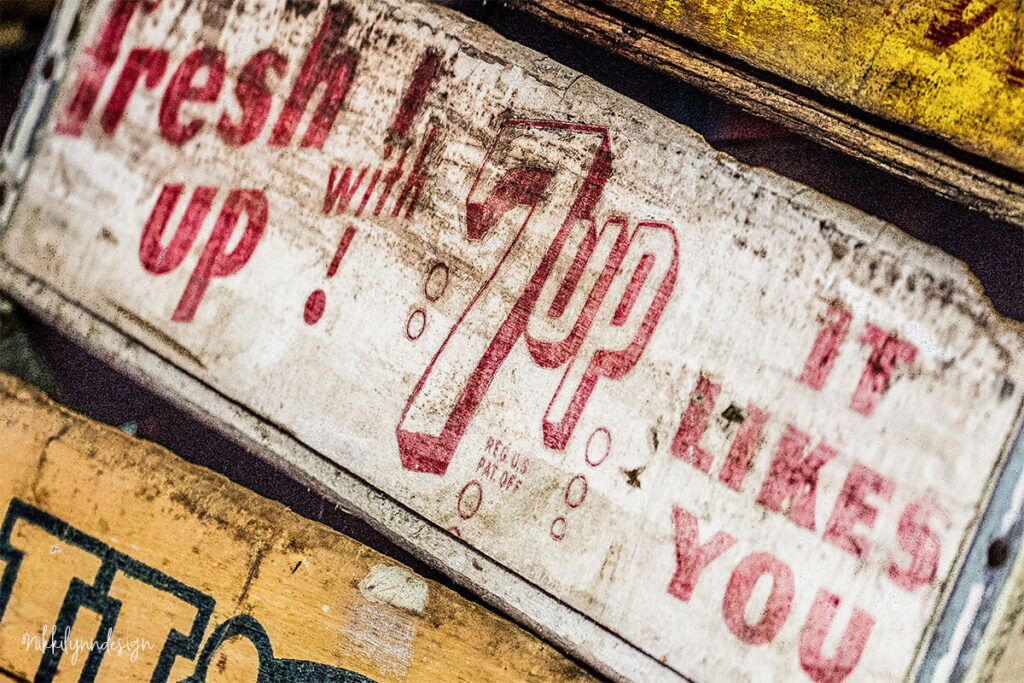 Vintage wooden 7-Up soda crate with Fresh Up with 7-Up It Likes You advertising slogan