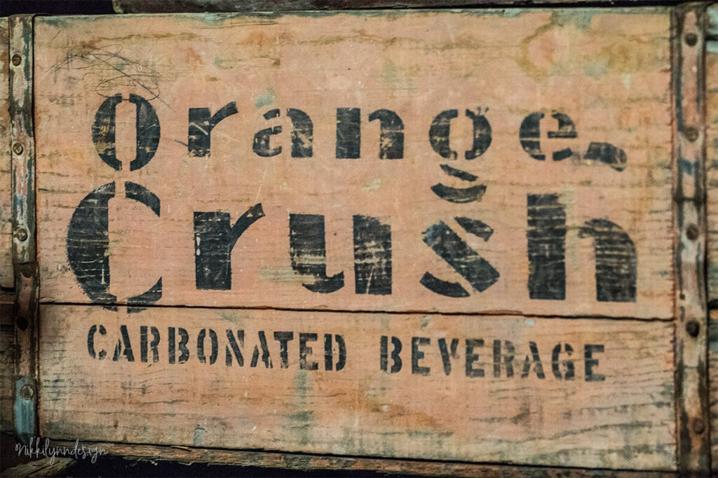 Vintage Orange Crush wooden soda crate with painted lettering for carbonated beverages